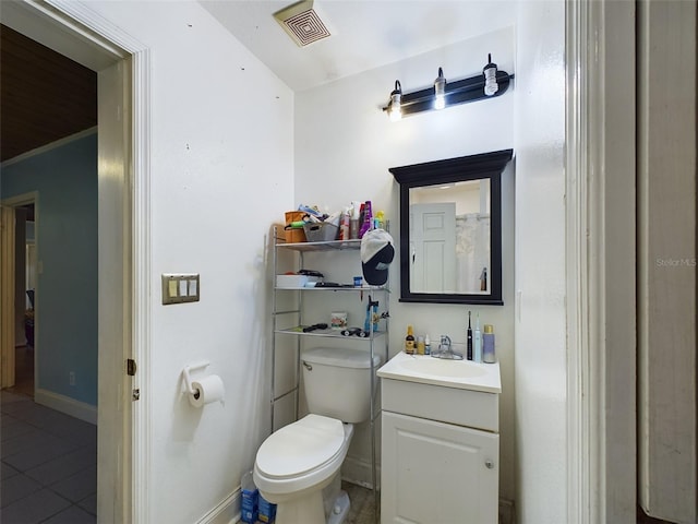 bathroom with vanity, toilet, and tile patterned floors