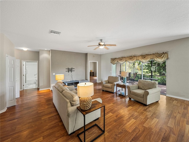 living room featuring a textured ceiling, hardwood / wood-style flooring, and ceiling fan