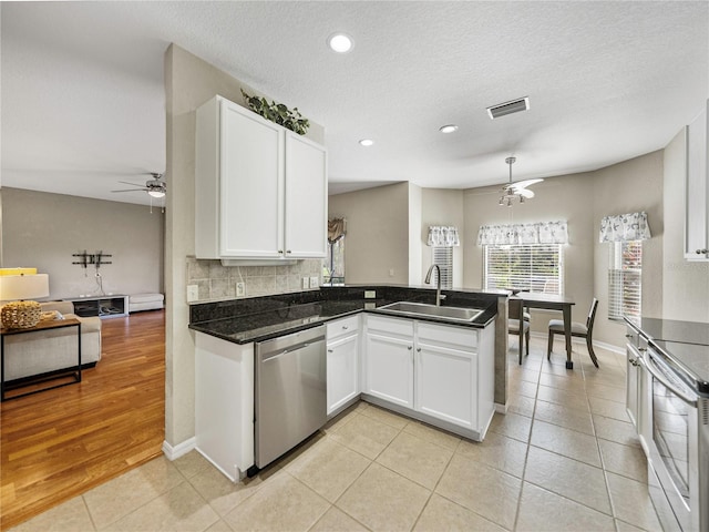 kitchen featuring kitchen peninsula, white cabinets, sink, and appliances with stainless steel finishes