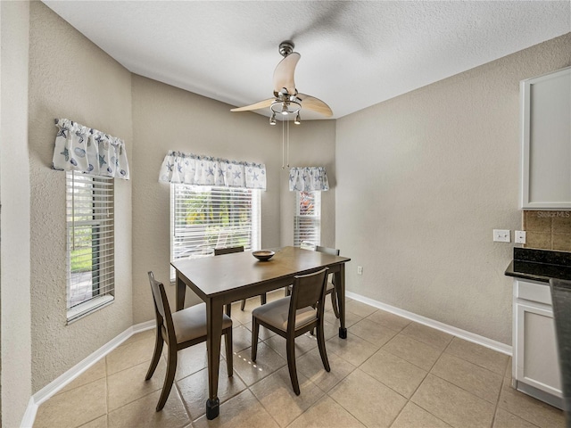 dining area featuring light tile patterned floors and ceiling fan