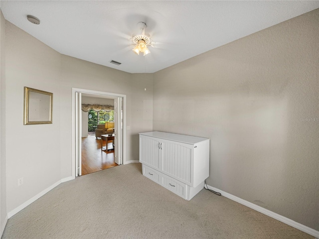 interior space with ceiling fan