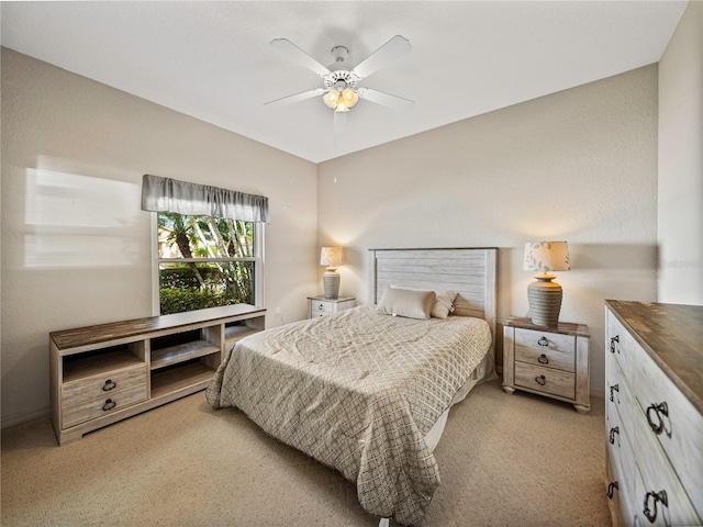 bedroom featuring light carpet and ceiling fan