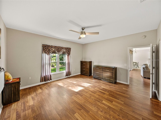 unfurnished bedroom featuring wood-type flooring and ceiling fan