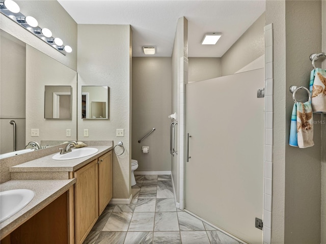 bathroom with toilet, vanity, and an enclosed shower