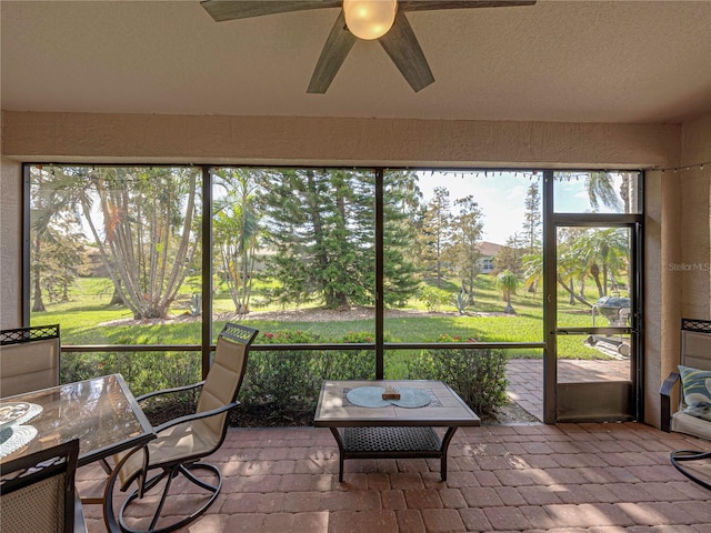 sunroom featuring ceiling fan