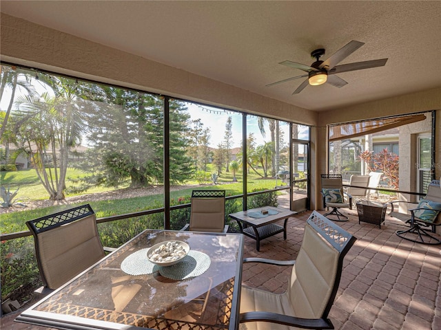 sunroom featuring ceiling fan