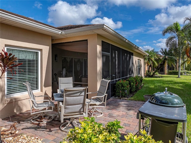 view of patio / terrace featuring a sunroom