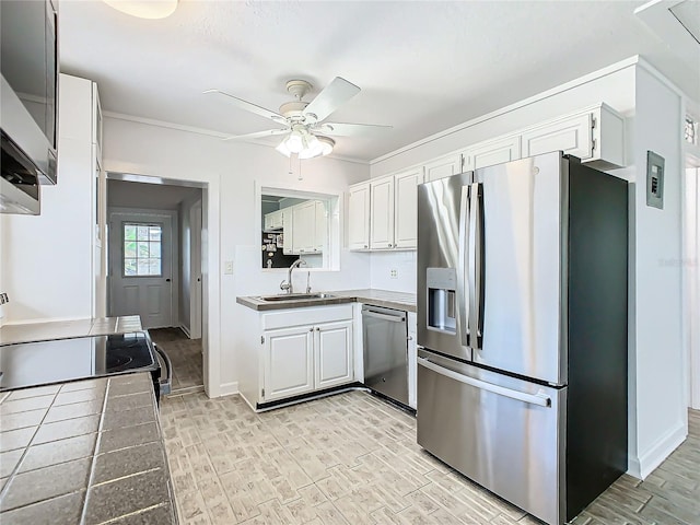 kitchen with sink, white cabinetry, stainless steel appliances, and light hardwood / wood-style floors