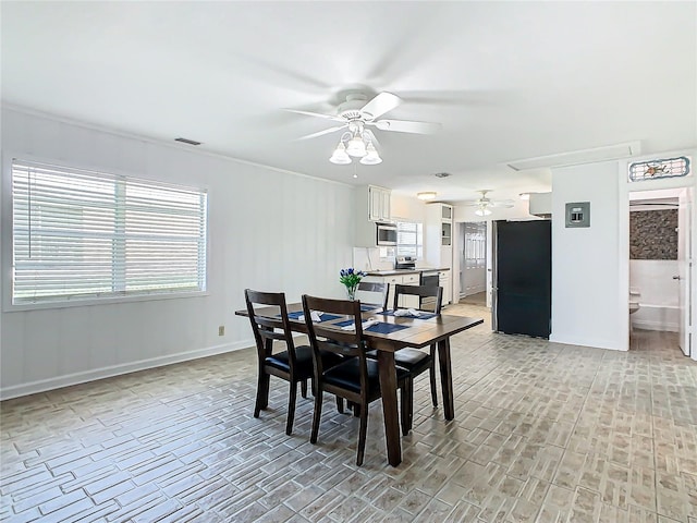 dining space with light wood-type flooring and ceiling fan