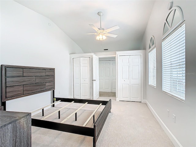 bedroom featuring vaulted ceiling, light carpet, and ceiling fan