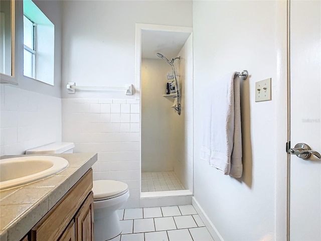 bathroom featuring toilet, walk in shower, tile walls, vanity, and tile patterned flooring