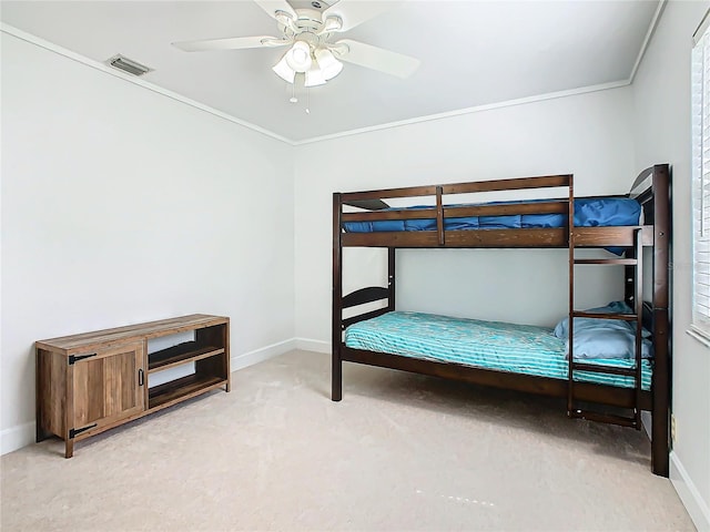 unfurnished bedroom featuring ornamental molding, light carpet, and ceiling fan