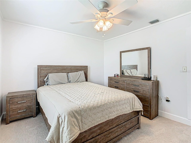 bedroom featuring ceiling fan, light carpet, and crown molding