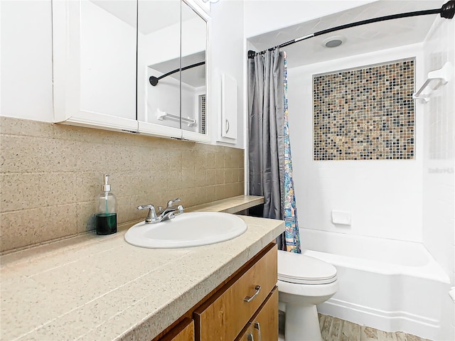 full bathroom featuring backsplash, vanity, shower / bath combo with shower curtain, and toilet