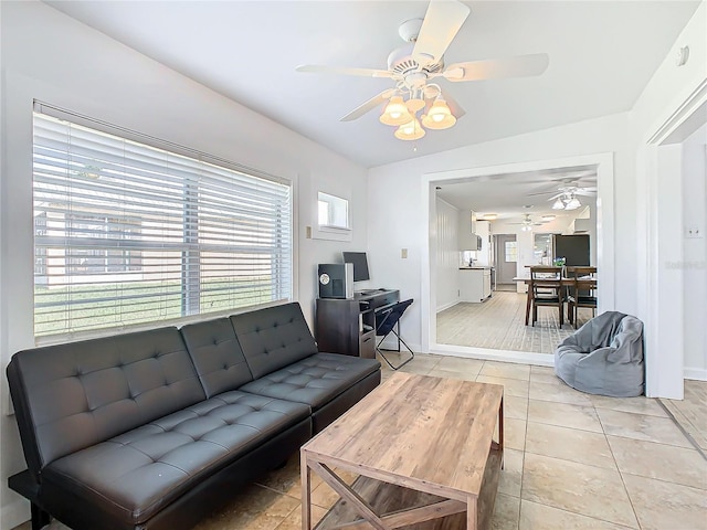 tiled living room with ceiling fan