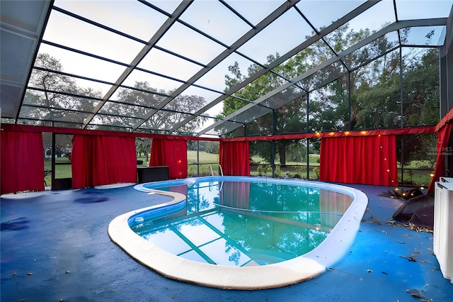 view of swimming pool with a lanai and a patio