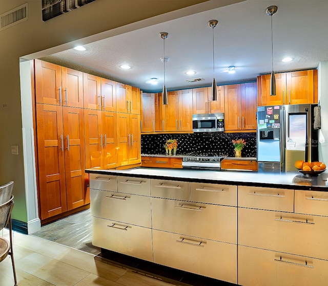 kitchen with stainless steel appliances, a textured ceiling, decorative light fixtures, light hardwood / wood-style flooring, and decorative backsplash