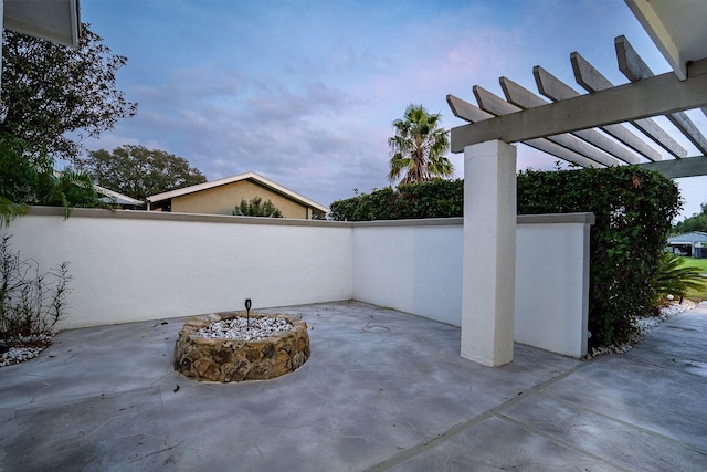 view of patio with a fire pit and a pergola