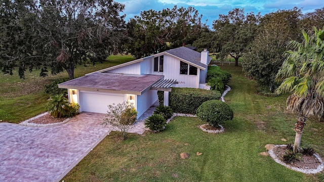 view of front of property with a garage and a front yard