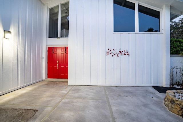 view of exterior entry featuring a patio area