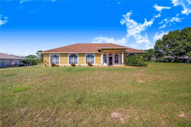 mediterranean / spanish home with a front lawn