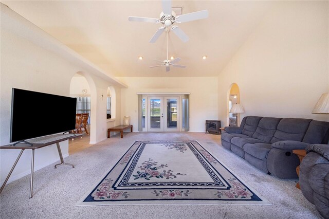 carpeted living room with vaulted ceiling and ceiling fan