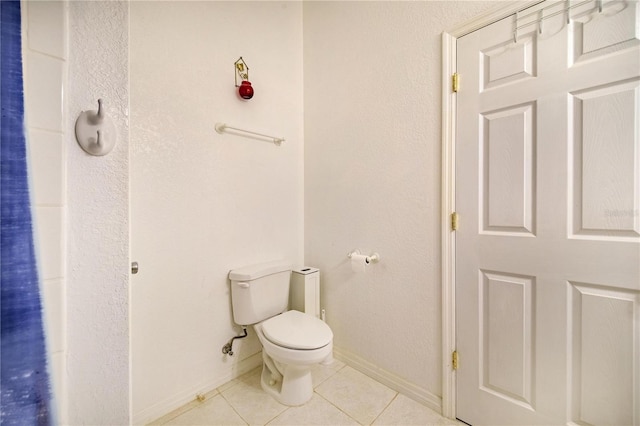 bathroom with toilet and tile patterned flooring