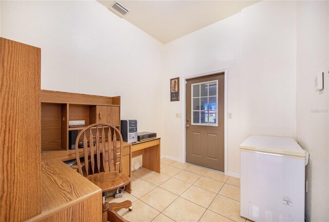 office area with built in desk and light tile patterned floors