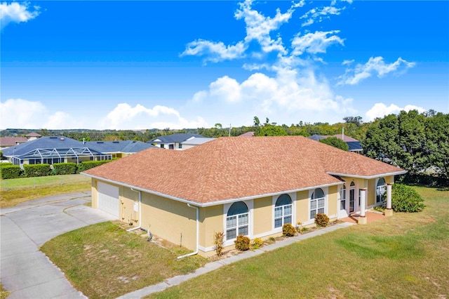 ranch-style home with a garage and a front lawn