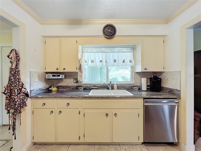 kitchen featuring tasteful backsplash, cream cabinets, sink, and stainless steel dishwasher