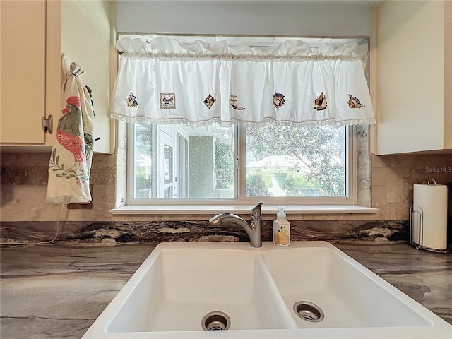 bathroom with decorative backsplash and sink