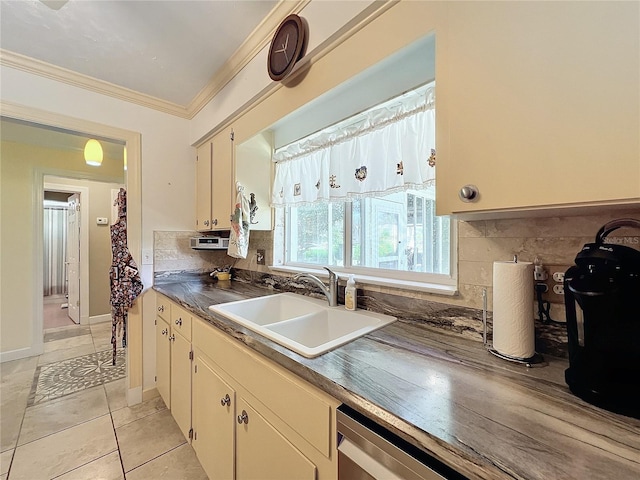 kitchen featuring sink, decorative backsplash, light tile patterned flooring, and ornamental molding