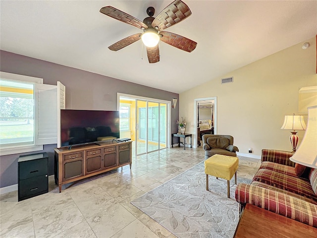 living room featuring ceiling fan and vaulted ceiling