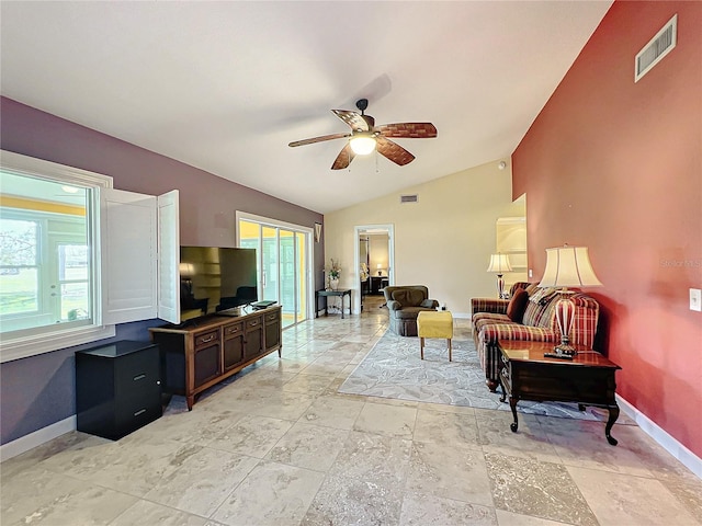 living room with ceiling fan, vaulted ceiling, and plenty of natural light