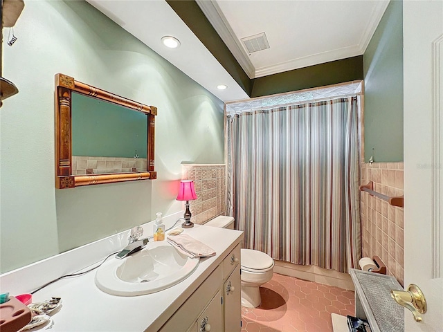 bathroom with tile walls, toilet, ornamental molding, vanity, and tile patterned flooring