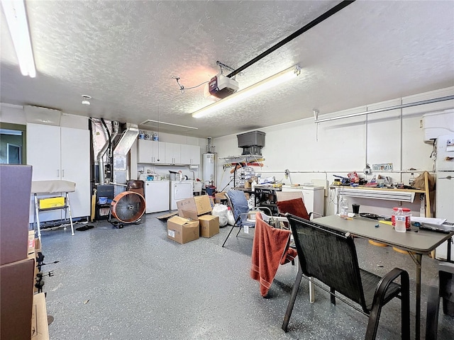 garage with a garage door opener, washer and clothes dryer, and gas water heater