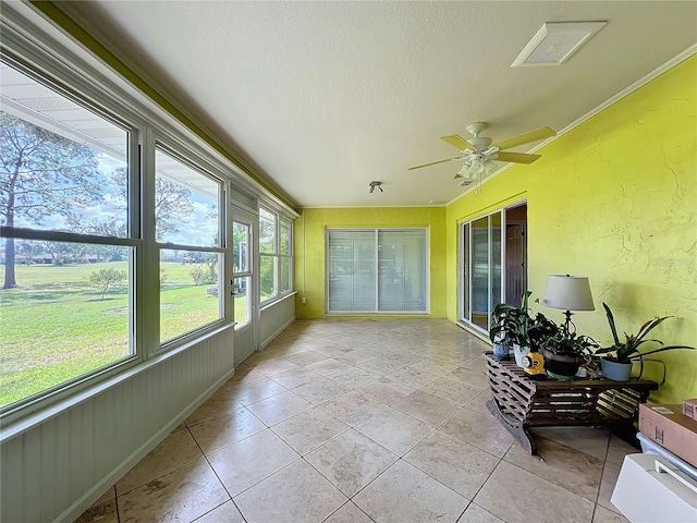 sunroom / solarium with ceiling fan and plenty of natural light