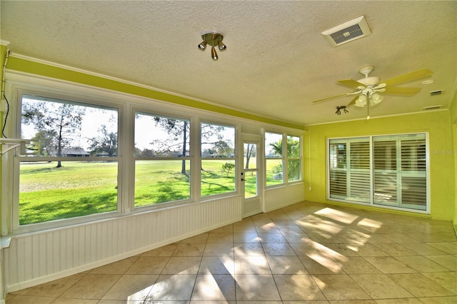 unfurnished sunroom with ceiling fan