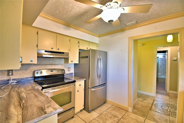 kitchen with appliances with stainless steel finishes, decorative backsplash, ornamental molding, light tile patterned floors, and ceiling fan