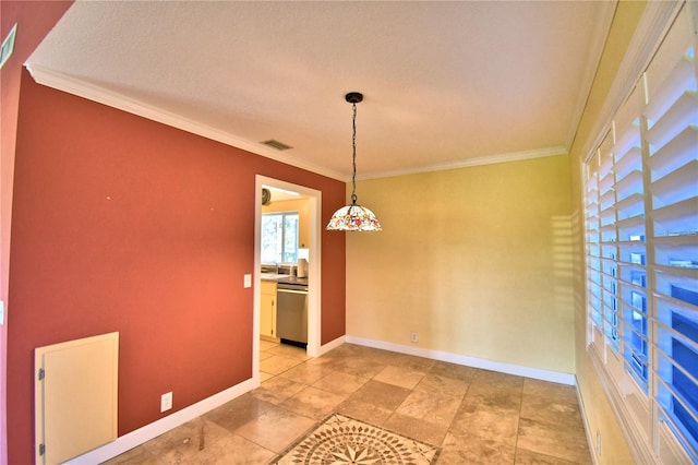 unfurnished dining area featuring ornamental molding and a textured ceiling