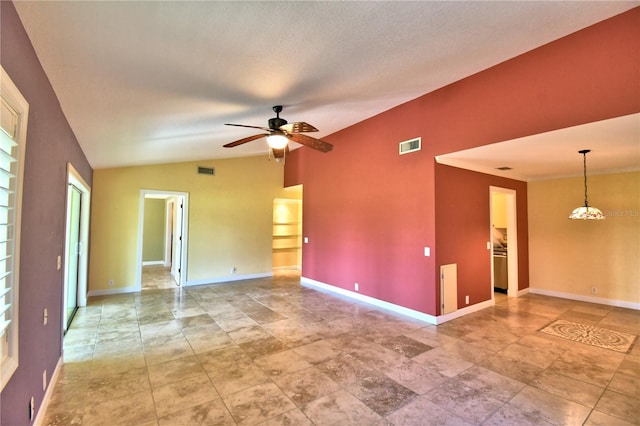 spare room with ceiling fan, vaulted ceiling, and a textured ceiling