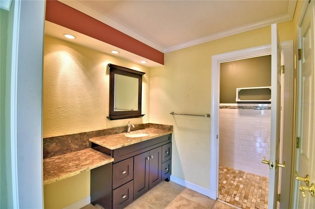 bathroom featuring ornamental molding, tile patterned flooring, and vanity