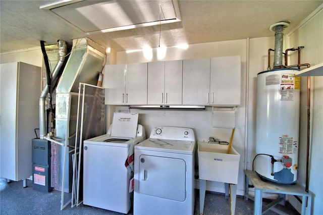 washroom with cabinets, gas water heater, washer and dryer, and sink