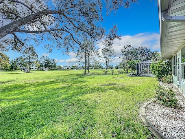 view of yard featuring glass enclosure