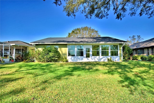 back of house with a lawn