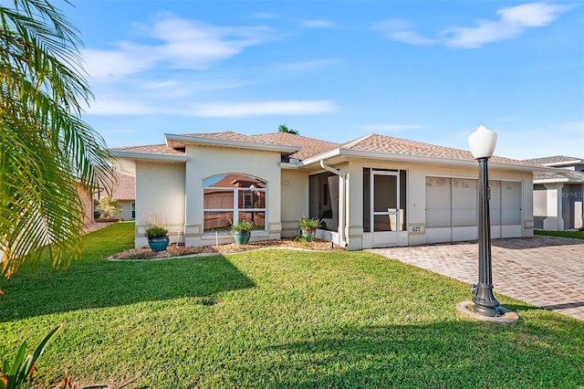 view of front of house with a garage and a front lawn