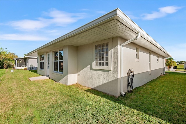 view of side of home with a lawn