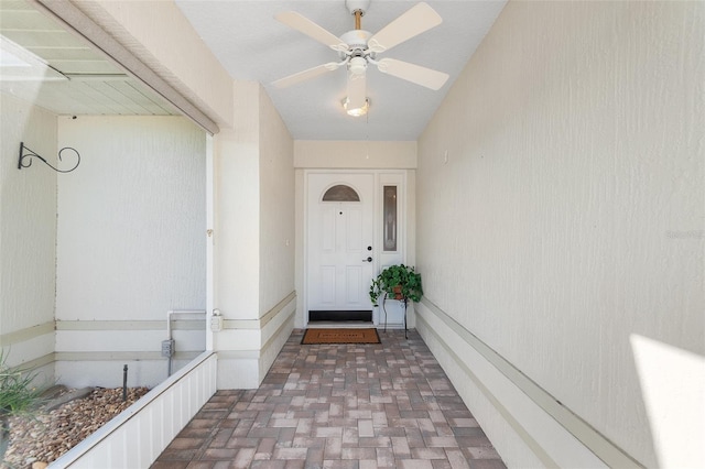 entrance to property featuring ceiling fan