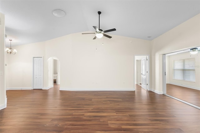 unfurnished living room with dark wood-type flooring, ceiling fan with notable chandelier, and lofted ceiling