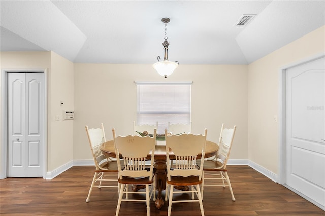 dining space with dark hardwood / wood-style flooring and vaulted ceiling